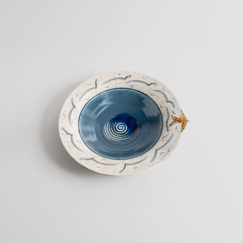 Blue ceramic platter with a little bird