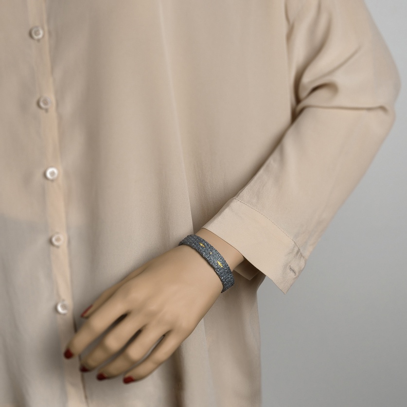 Silver bracelet of intricate detail with gold and diamond