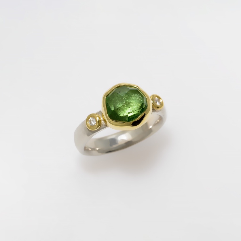 Sparkling ring with green tourmaline and two diamonds