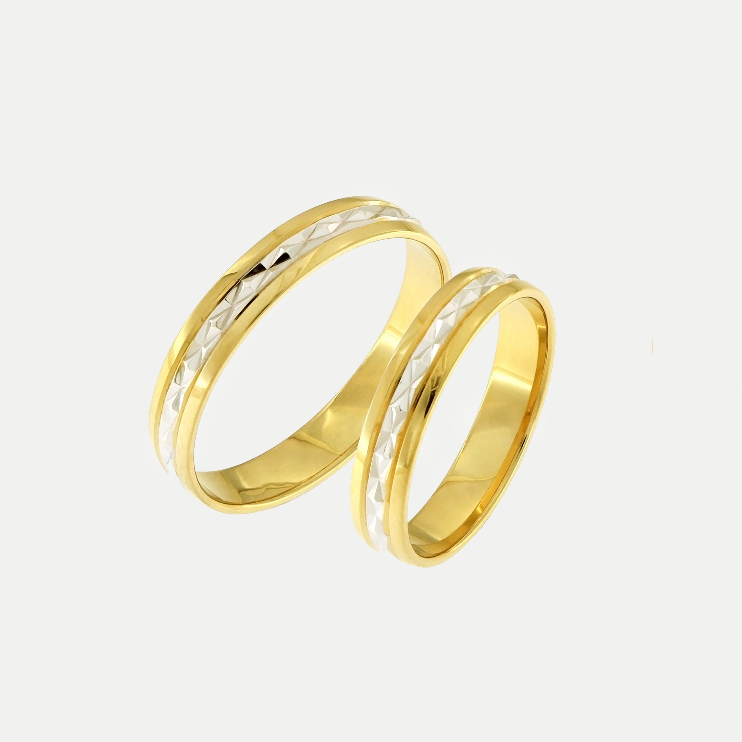Yellow and white gold wedding rings with a diamond-cut pattern